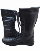 Unisex black leather dark champion wrestling boots with white star accent, flat black athletic rubber sole, and stitched welt construction on white background