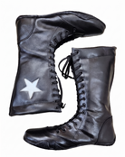 Close-up of white star appliqué patch precision-stitched onto black leather wrestling boot 