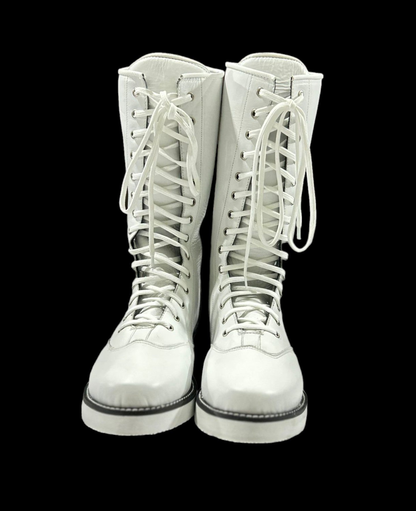 White lace-up boots on a black background