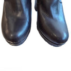 Pair of black leather boots on a white background