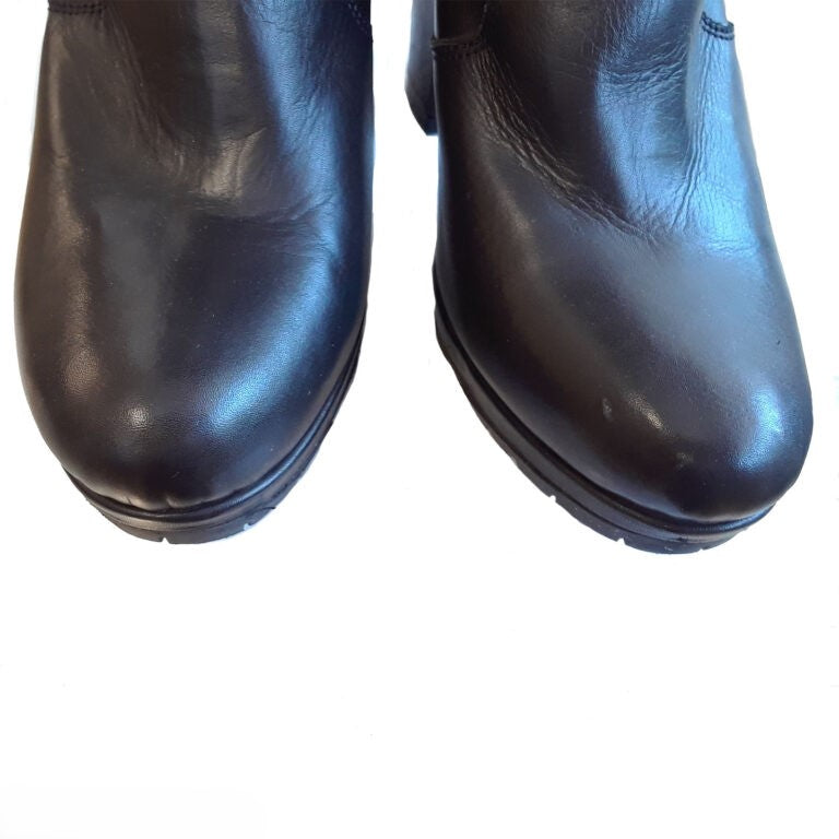 Pair of black leather boots on a white background