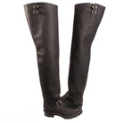 Pair of black knee-high boots with buckles on a white background