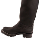 Brown leather boot worn with black tights on a white background