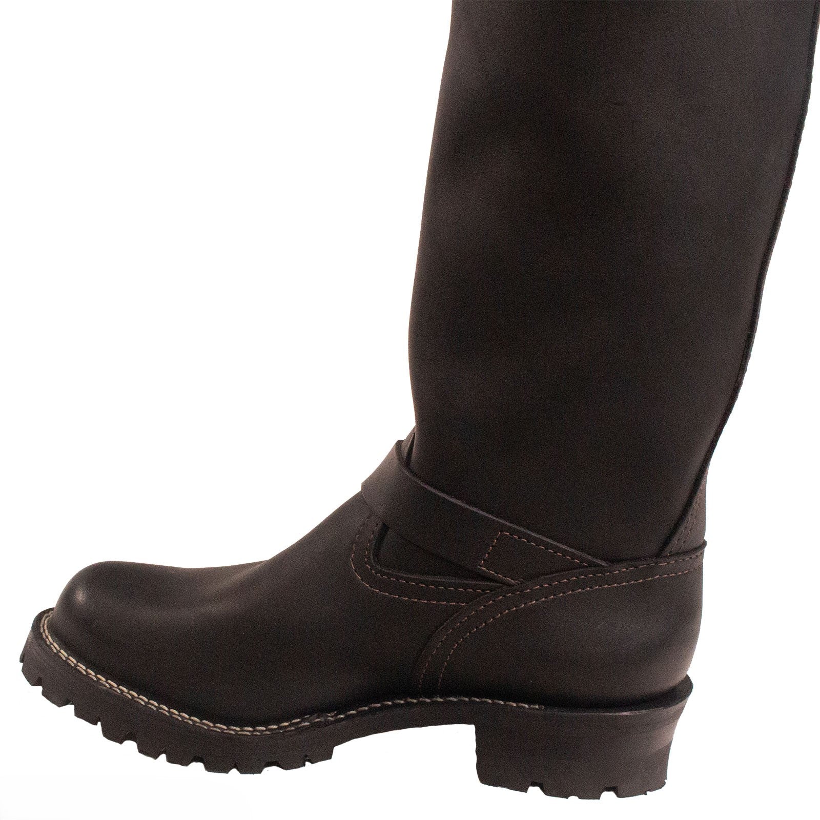 Brown leather boot worn with black tights on a white background