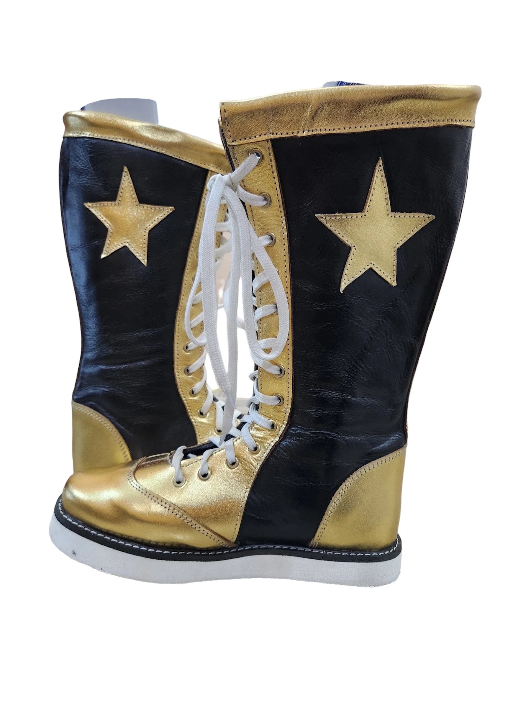 Black and gold boots with white laces on a white background