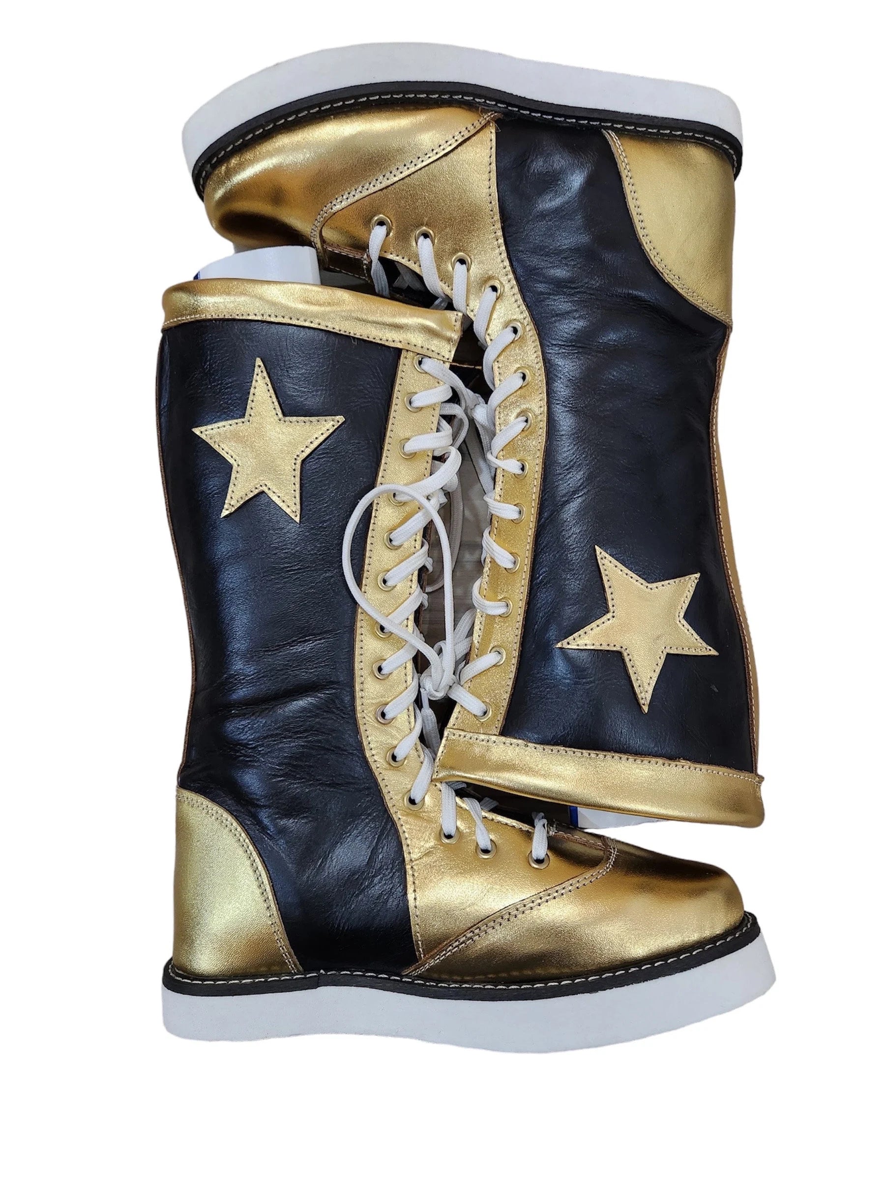 Black and gold high-top sneakers with white stars on a white background