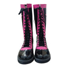 Black and pink combat boots with glossy finish on a white background