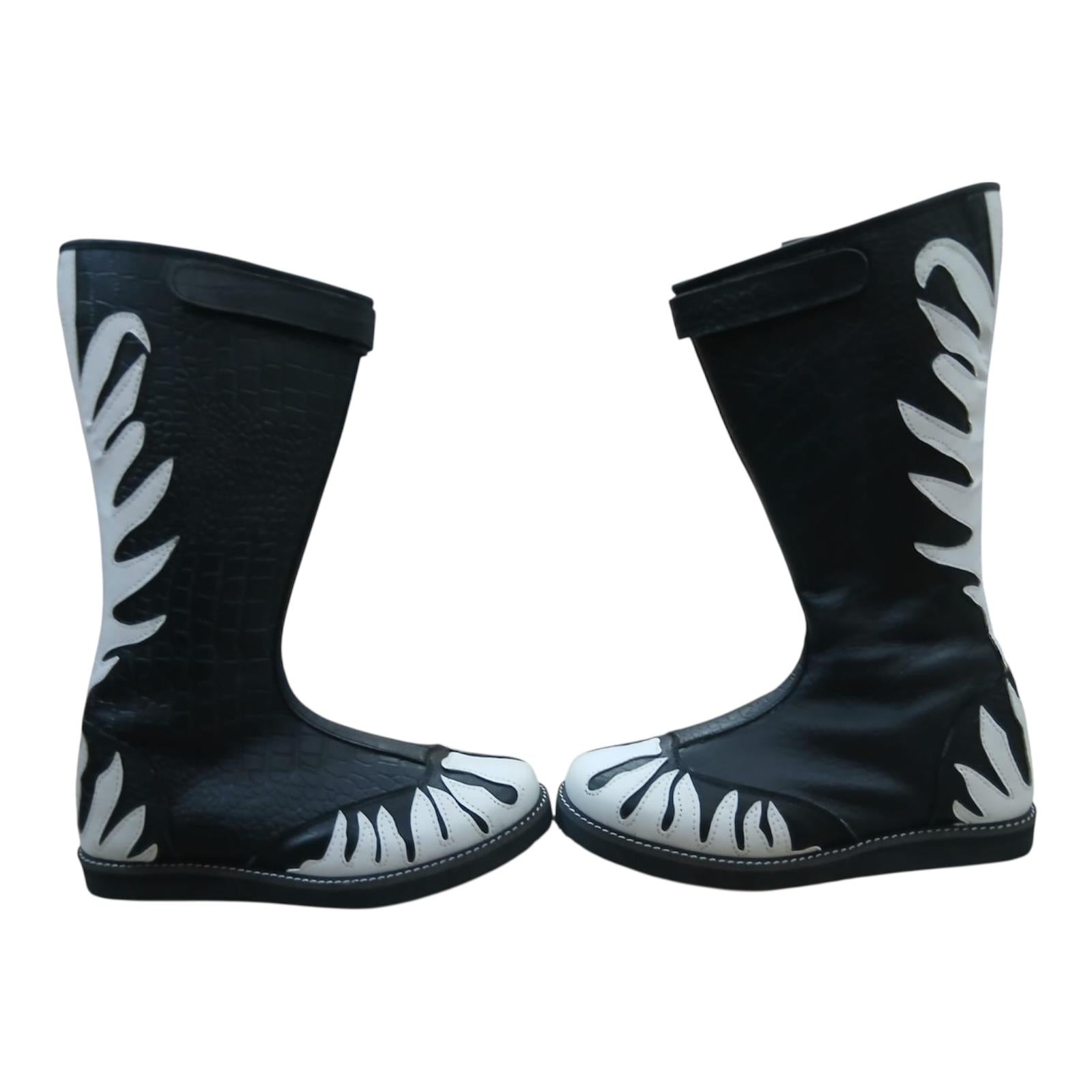 Close-up of crocodile-embossed leather texture on black professional wrestling boot shaft
