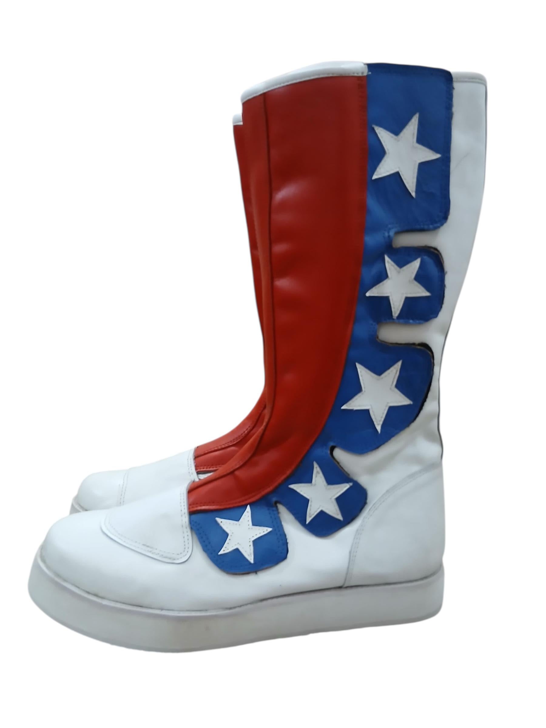 Side profile of All-American professional ring boots showing four white star patches on blue leather wave panel graduating from toe to upper shaft