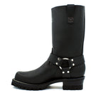 Close-up of chrome D-ring and polished nickel rivet harness strap system wrapping ankle of black oiled leather engineer boot