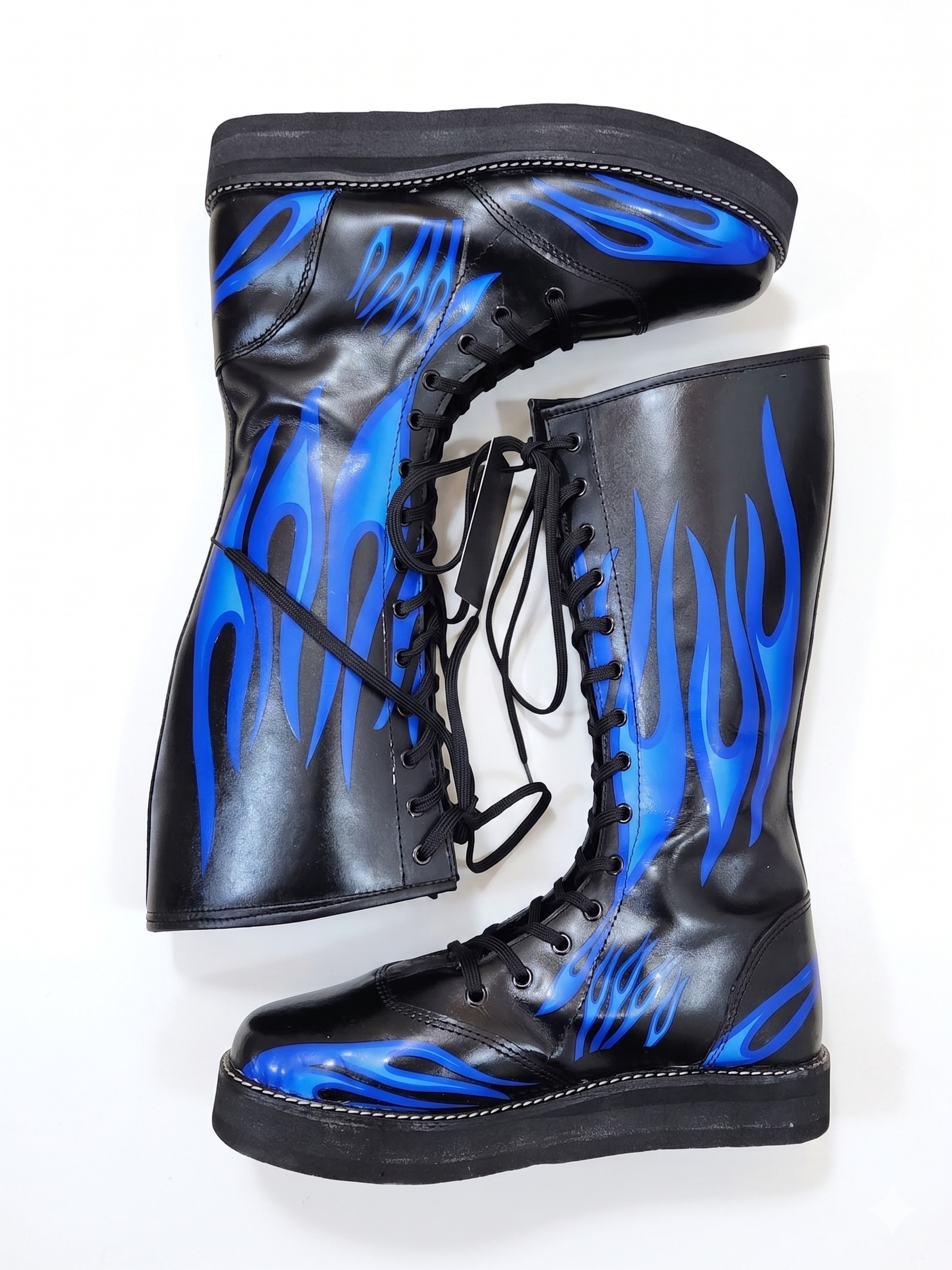 Front-facing pair of black inferno wrestling boots displaying vivid blue flame artwork covering both shaft panels and toe box